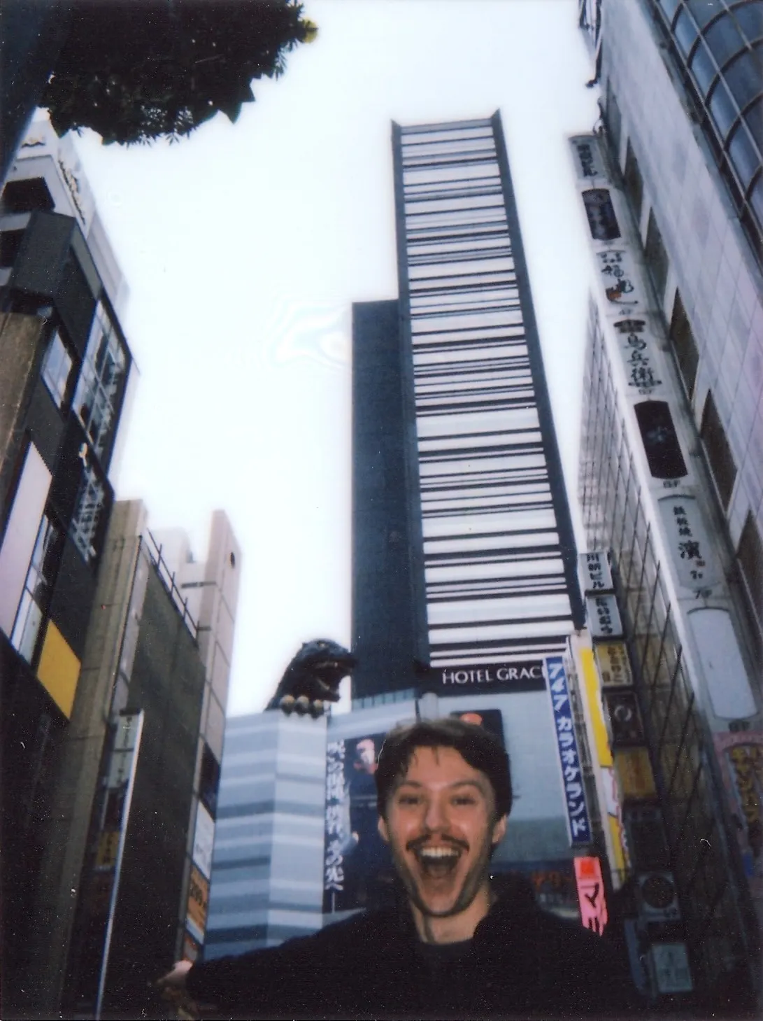 Max in front of Godzilla hotel statue in Shinjuku, Tokyo, Japan